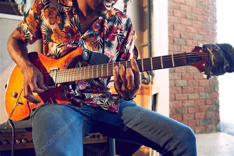 Male Musician Playing Electric Guitar In Garage Stock Image F