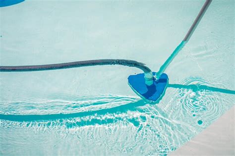 Premium Photo | Swimming pool cleaning tools in the bottom of the pool ...