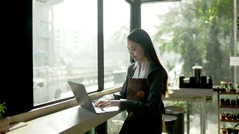 Owner of Coffee Shop or Restaurant Working on Laptop in Her Shop in The ...