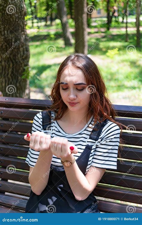 A Pretty Red Haired Girl Examines Her Manicure Stock Image Image Of