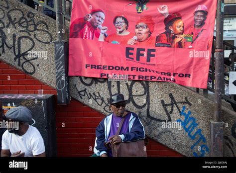 An Economic Freedom Fighters Banner Is Seen As People Listen To