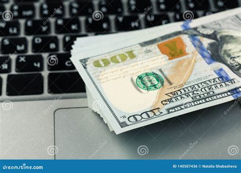 Closeup View Of One Hundred Dollar Banknotes Lying On The Laptop