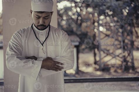 Young asian muslim man praying on sunset,Ramadan festival concept ...