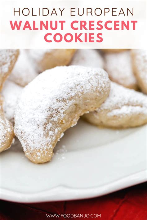 A White Plate Topped With Cookies Covered In Powdered Sugar On Top Of A