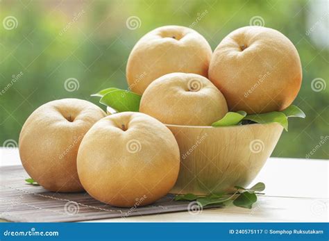 Fresh Korean Pear Or Nashi Pear Fruit In The Basket Over Green Natural