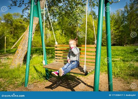 Child Swinging A Swing Child Sitting On A Swing Stock Image Image Of