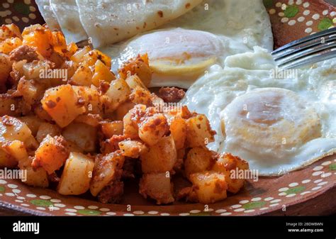 Over Medium Eggs With Potatoes And Chorizo Or Huevos Estrellados Con