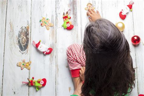 Little Girl with Christmas Pajamas Playing with Christmas Decorations ...