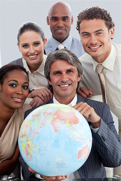 Cheerful Business Team Showing A Terrestrial Globe