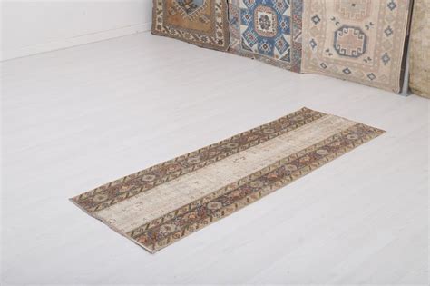 rugs are arranged on the floor in an empty room with white walls and floors