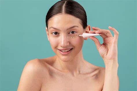 Free Photo Front View Woman Applying Face Cream