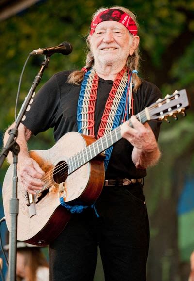 Willie Nelson looking awesome as usual in a headband and a stylish guitar strap #JazzFest # ...