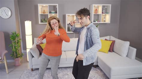 Mother and son dancing. Mother and son are dancing happily at home ...
