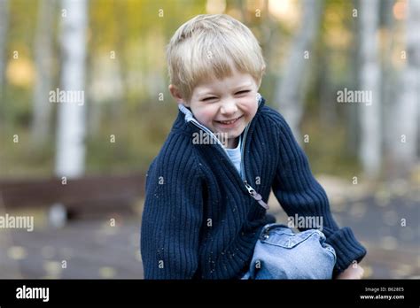 Little Boy Crouched Down Giggling Stock Photo Alamy