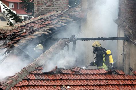 Firefighters burning house — Stock Photo © Belish #64537209