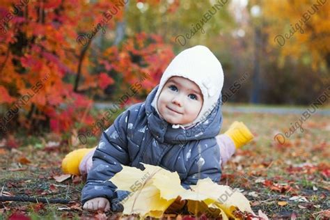 Cute smiling little girl is lying on a grass.