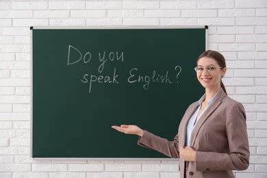 English Teacher Giving Lesson On Modal Verbs Near Whiteboard In