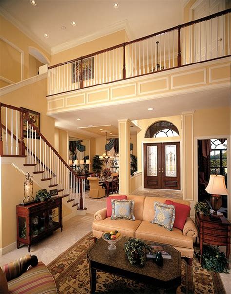 A Living Room Filled With Furniture And A Stair Case