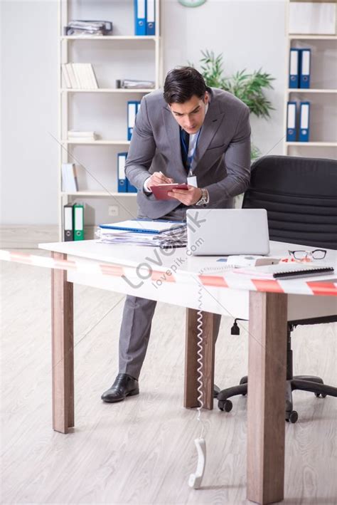 Forensic Investigator Taking Pictures At Office Crime Scene Picture And