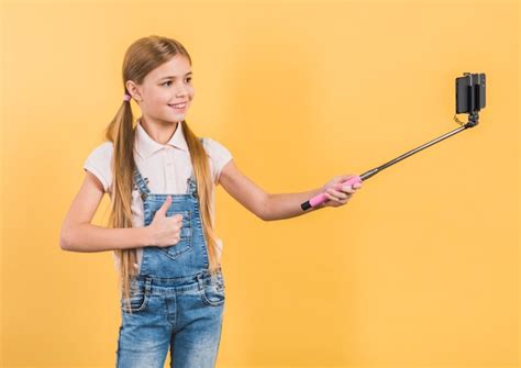 Free Photo Smiling Portrait Of A Girl Showing Thumb Up Sign Taking