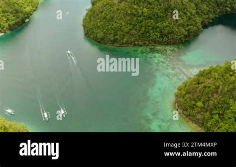 Cove And Blue Lagoon Among Small Islands Covered With Rainforest Sugba