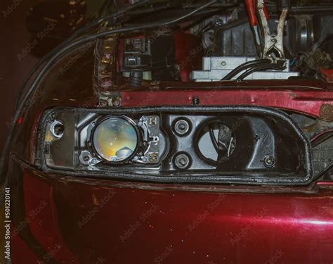 Installing the headlight on the car. Repair of car headlights. Tuning ...