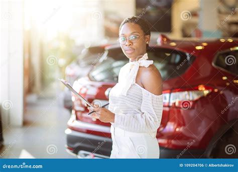 Professional Female Salesperson Working in Car Dealership Stock Photo ...