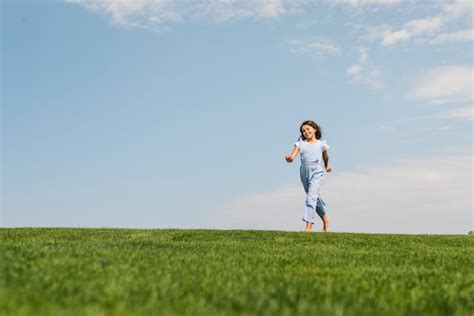 Free Photo | Girl running barefoot on grass