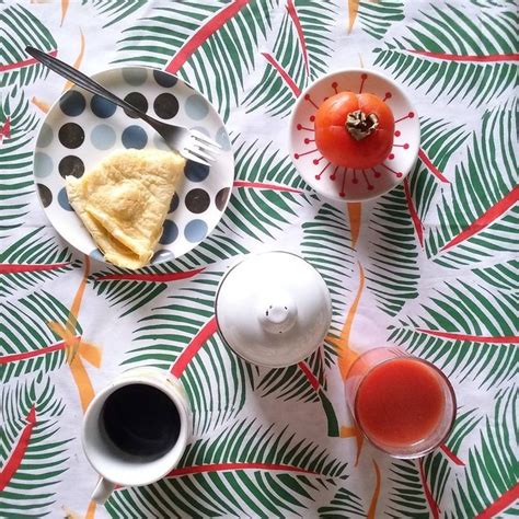 A Table Topped With Plates And Cups Filled With Food