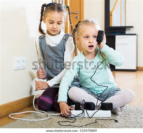 Little American Children Playing With Sockets And Electricity Indoors