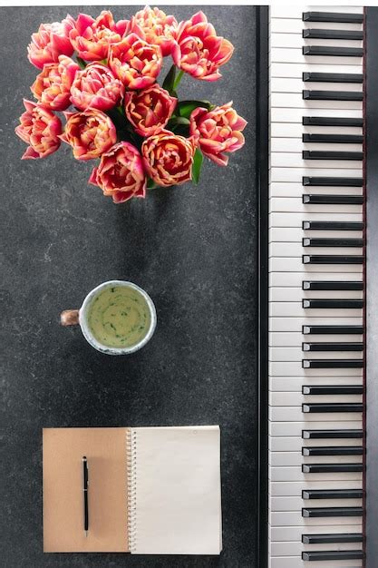 Free Photo Piano Bouquet Of Spring Flowers Notepad And Cup Of Tea On