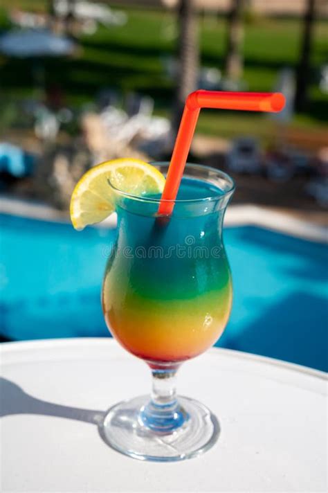 Colourful Cold Rainbow Paradise Cocktail Drink Served In Glass At Pool