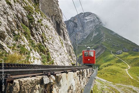 Cogwheel Train Passing Mountain Landscape Of Swiss Alps Red Train On