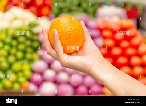 Woman Holding Orange In Supermarket Stock Photo Alamy