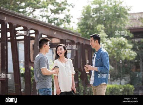 Cheerful young friends talking outdoors Stock Photo - Alamy