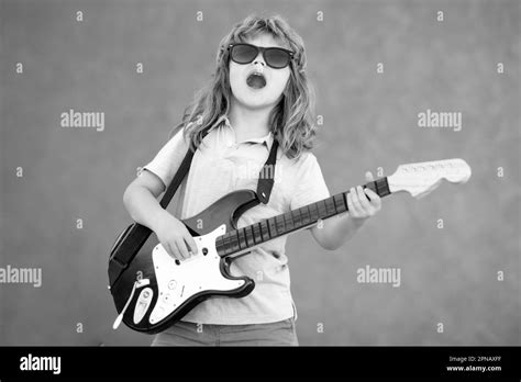 Child Musician Guitarist Playing Electric Guitar Kid Boy With Guitar