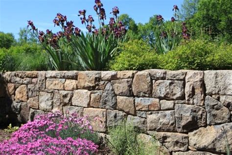 Garden stone wall provides slope stability and privacy protection