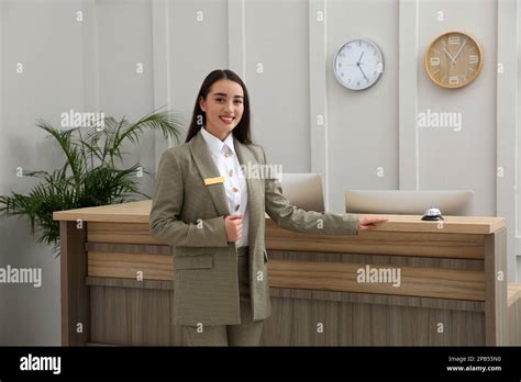 Portrait Of Beautiful Receptionist Near Counter In Hotel Stock Photo