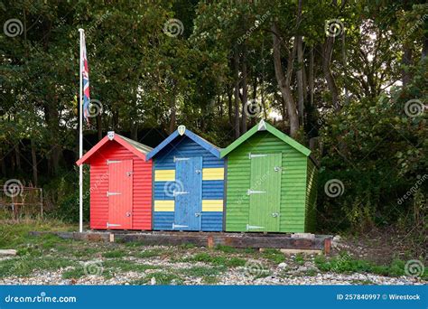 Colourful Beach Huts With Lush Trees In The Background Stock Image