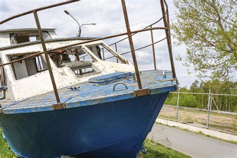 Abandoned Wrecked Boat Lying On The Shore Waiting For Repairs Fishing