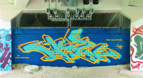 Graffiti Art on Blue Brick Wall