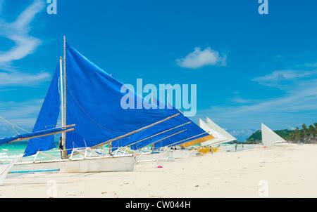 Traditional Paraw Sailing Boats On White Beach On Boracay Island