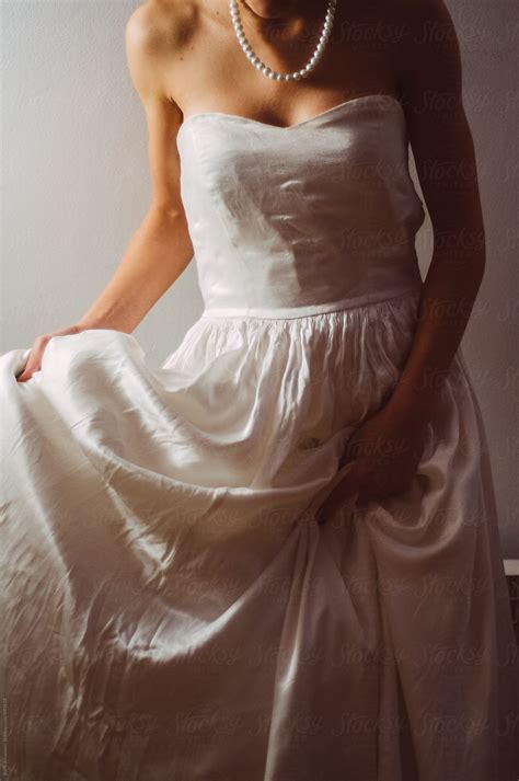 Bride Holding Her Dress By Stocksy Contributor Boris Jovanovic Stocksy