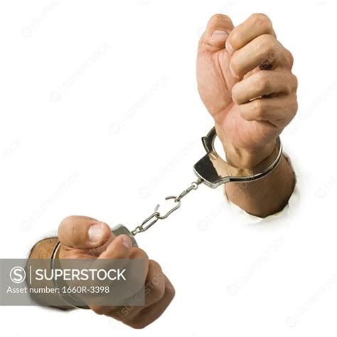 Close Up Of Hands Trying To Break Out Of Handcuffs Superstock