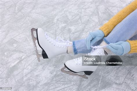 Woman Lacing Figure Skates On Ice Above View Stock Photo Download