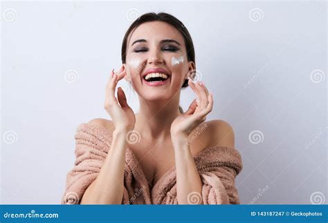 Happy Beautiful Young Woman Applying Cream At Her Face Close Up Stock