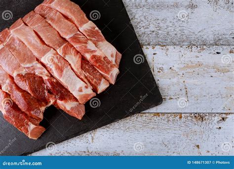 Neatly Sliced Uncooked Fresh Raw Pork On Cutting Board Stock Image