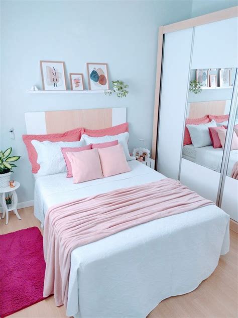 A Bedroom With Pink And White Decor On The Walls Bed Linens And Mirror