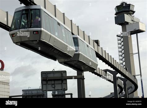 Skytrain, Duesseldorf International Airport, Germany. Leaving Airport with flight control tower ...