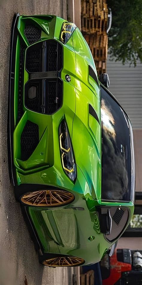 A Green Sports Car Parked On The Side Of A Building